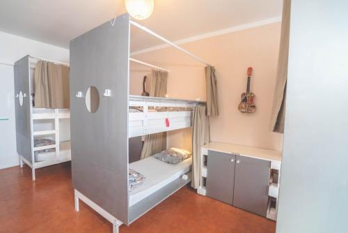 a large gray bunk bed in a room at La Maïoun Guesthouse in Nice