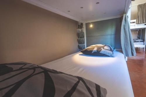 a bedroom with a bed with a light on it at La Maïoun Guesthouse in Nice