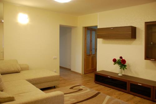 a living room with a couch and a vase of flowers on a table at DreamLand in Poprad