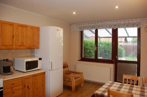 a kitchen with a white refrigerator and a table at DreamLand in Poprad