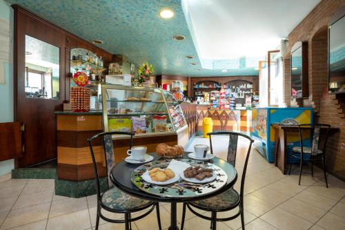 a table with a plate of food on it in a store at Cottoni Natural Space in Valtopina
