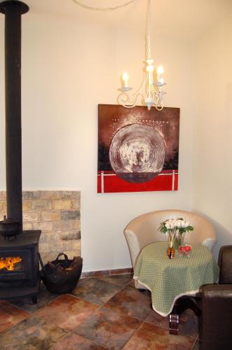 a living room with a table and a fireplace at Zimmerke in Bruchim Qela' Alon
