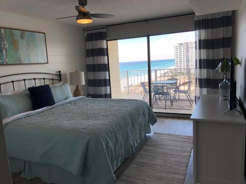 a bedroom with a bed and a view of the ocean at Regency Towers - beachfront condo in Panama City Beach