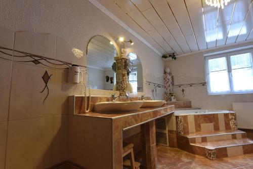 a bathroom with two sinks and a large mirror at Apartment Fernerkogel in Gries im Sellrain