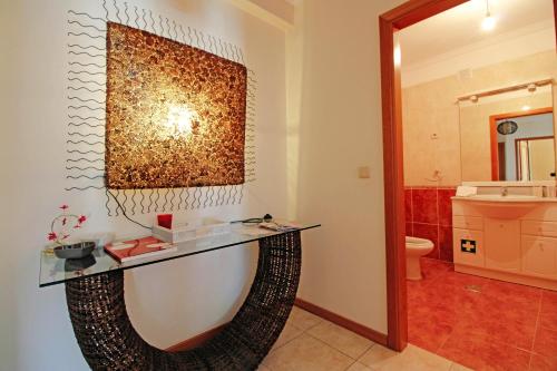 a bathroom with a glass counter on the wall at Senhora das Areias - Spacious Apt near the Cabedelo Beach in Viana do Castelo