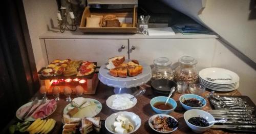 a table topped with lots of different types of food at Tsarbou Guesthouse in Stemnitsa