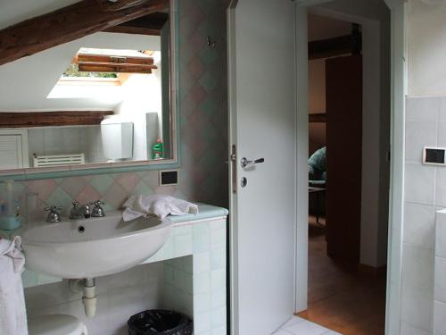 a bathroom with a sink and a mirror at Rosignano Bed and Car in Castiglioncello