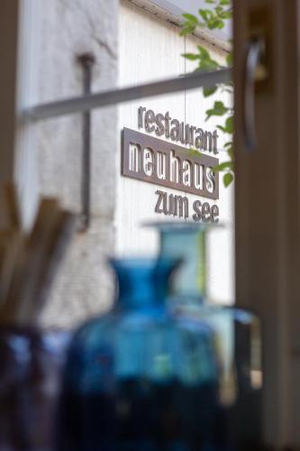a blue vase sitting in front of a sign at Neuhaus Golf- & Strandhotel in Interlaken
