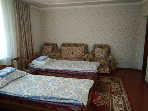 Postel nebo postele na pokoji v ubytování Meerim Guest House