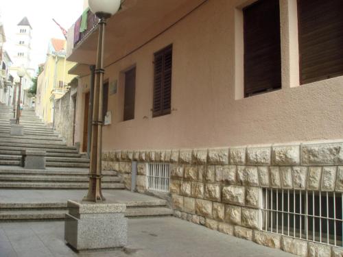 a street light in front of a building with stairs at Apartments Popov in Crikvenica