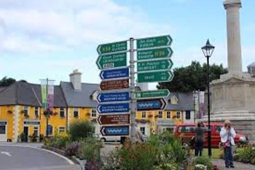 a bunch of street signs on a pole at The Rocks in Westport