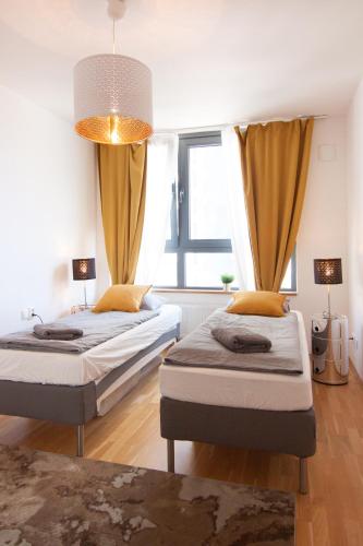 a bedroom with two beds and a window at Apollo Apartment - Key-Box - Free Parking in Bratislava