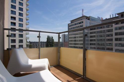 a balcony with a white bench on a building at Apollo Apartment - Key-Box - Free Parking in Bratislava