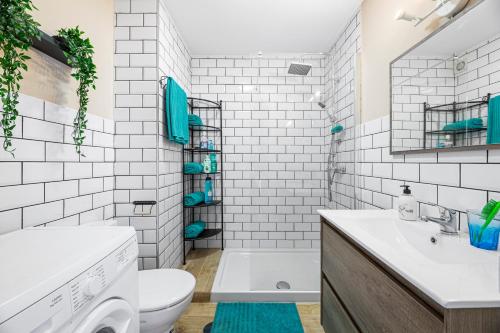 a bathroom with a sink and a toilet and a tub at The Colors House, 653 y 654 - Private Apartment in Costa Teguise