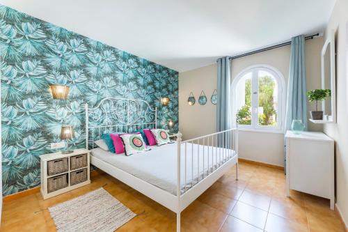 a bedroom with a bed with a blue and green wallpaper at The Colors House, 653 y 654 - Private Apartment in Costa Teguise