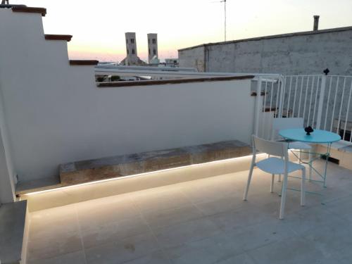 a balcony with a table and a chair on a building at San Pietro al Borgo in Molfetta