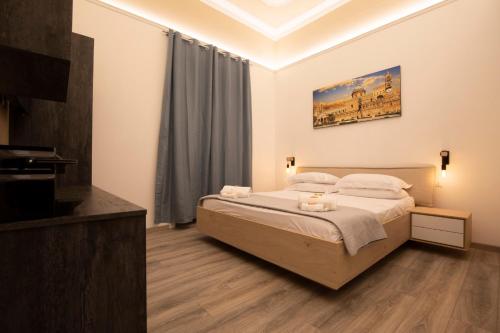 a bedroom with a bed and a television in it at Sammartino suite in Palermo