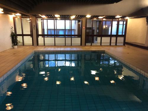 a swimming pool with lights in a building at Unique Alpic style apartment in the heart of Davos in Davos