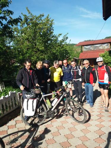 a group of people standing next to a bike at Casa Ana in Biertan