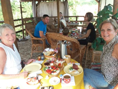 people sitting around a table eating food at Casa Ana in Biertan
