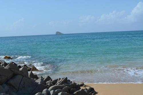 a group of rocks on a beach near the ocean at Middle Country 97-1 "la recette du bonheur" in Deshaies