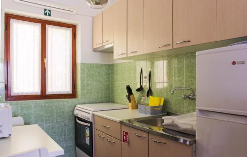 a kitchen with a sink and a refrigerator at Twin Oaks in Šišan