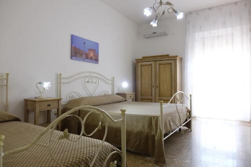 Uma cama ou camas num quarto em Don Nicola Residence