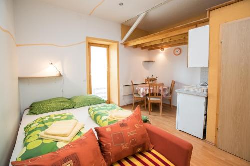 a small bedroom with a bed and a couch at APARTMA KAMNJE in Bohinj