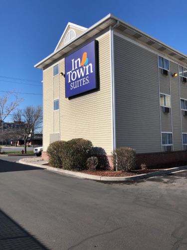 a building with a sign for a tum tum suites at InTown Suites Extended Stay Salt Lake City UT - South in South Salt Lake