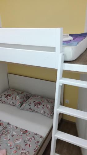 a white bunk bed in a room with a mattress at Apartment Lana in Izola