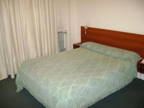a bedroom with a bed with a wooden head board at Real Splendid Hotel in Buenos Aires