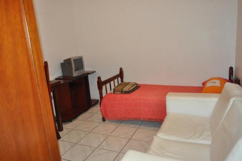 מיטה או מיטות בחדר ב-Hospedagem Centro Champagnat