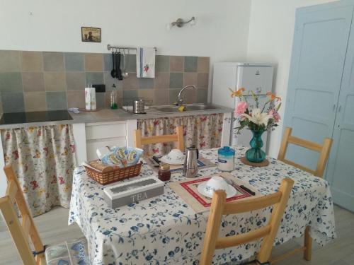 a kitchen with a table with a table cloth and a tableablish at Chez Bonjour in Villar Pellice