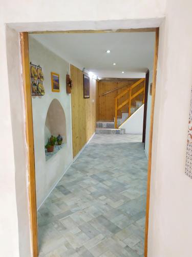 a hallway of a house with a staircase and a room with a tile floor at Siracusa Ortigia by Duomo in Siracusa