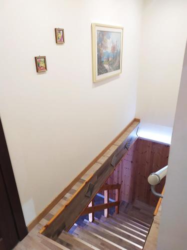 a staircase in a building with a picture on the wall at Siracusa Ortigia by Duomo in Siracusa
