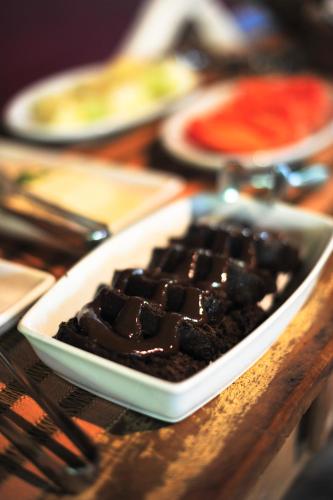 a plate of chocolate dessert on a wooden table at Pousada Manacás in Cavalcante