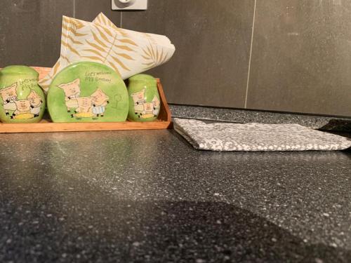 two green towels on a counter in a bathroom at Lux Apartament in Zalău