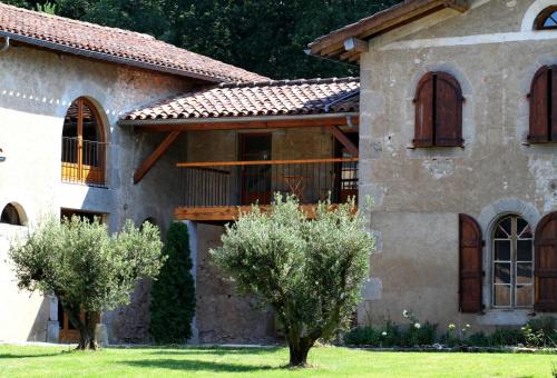 an exterior view of a house with trees in the yard at Domaine Le Castelet in Castres