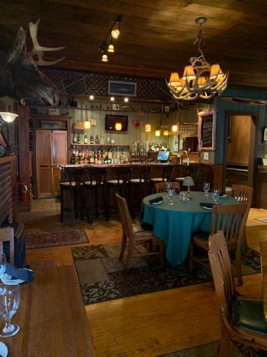 a dining room with a table and a bar at Waybury Inn in East Middlebury