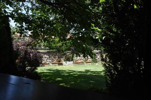 a view through the trees of a green yard at Villa Serz in Bitola