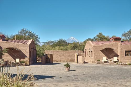 a group of brick buildings with two arches at Hotel La Casa de Don Tomás in San Pedro de Atacama