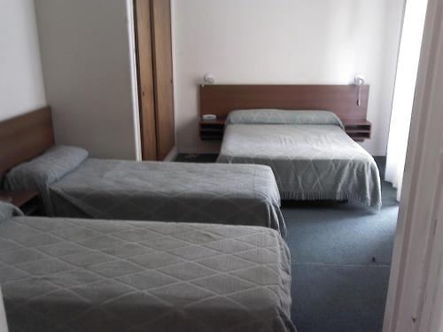 two beds in a hotel room with at Real Splendid Hotel in Buenos Aires