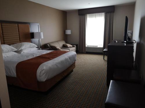 a hotel room with a bed and a window at Best Western Plus Hinton Inn & Suites in Hinton