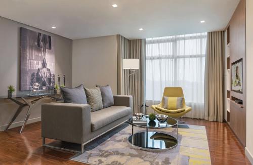 a living room with a couch and a table at Citadines Millennium Ortigas Manila in Manila