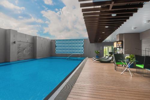 a swimming pool on the roof of a building at Citadines Millennium Ortigas Manila in Manila