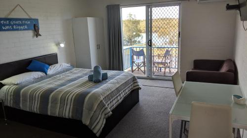 a bedroom with a bed with a stuffed animal on it at Harrington Village Motel in Harrington