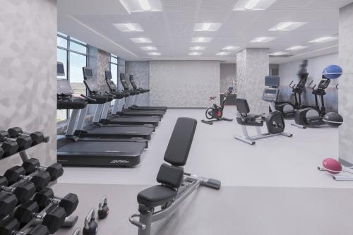 a gym with rows of exercise bikes and treadmills at Residence Inn by Marriott Halifax Dartmouth in Halifax