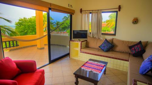 a living room with a couch and a tv at Las Turquezas in Puerto Escondido