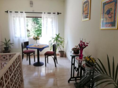 a living room with a table and chairs at Pousada Bem Querer in Penedo