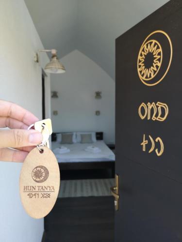 a person holding a key chain in front of a door at Hunnia - Huntanya in Vlăhiţa